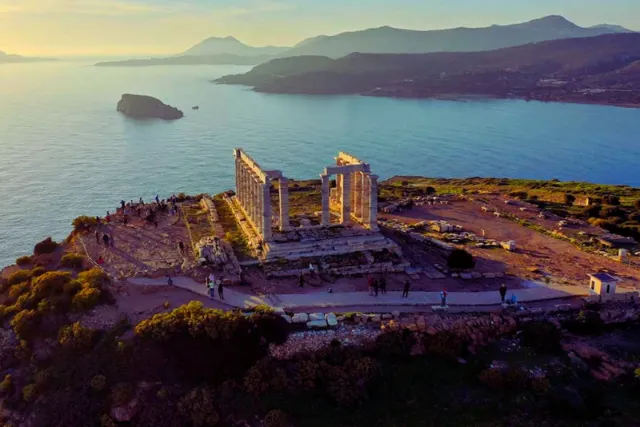 Temple of Poseidon on the headland at Cape Sounion above the Saronic Gulf at sunset