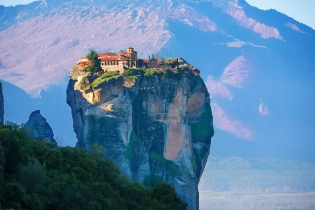 A monastery built on the flat top of a single rock pillar at Meteora