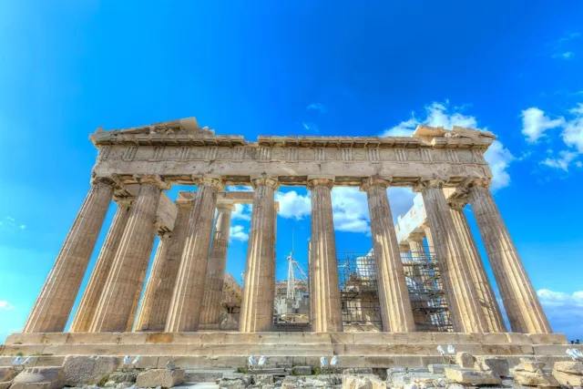The Parthenon columns on the Acropolis of Athens under a bright blue sky